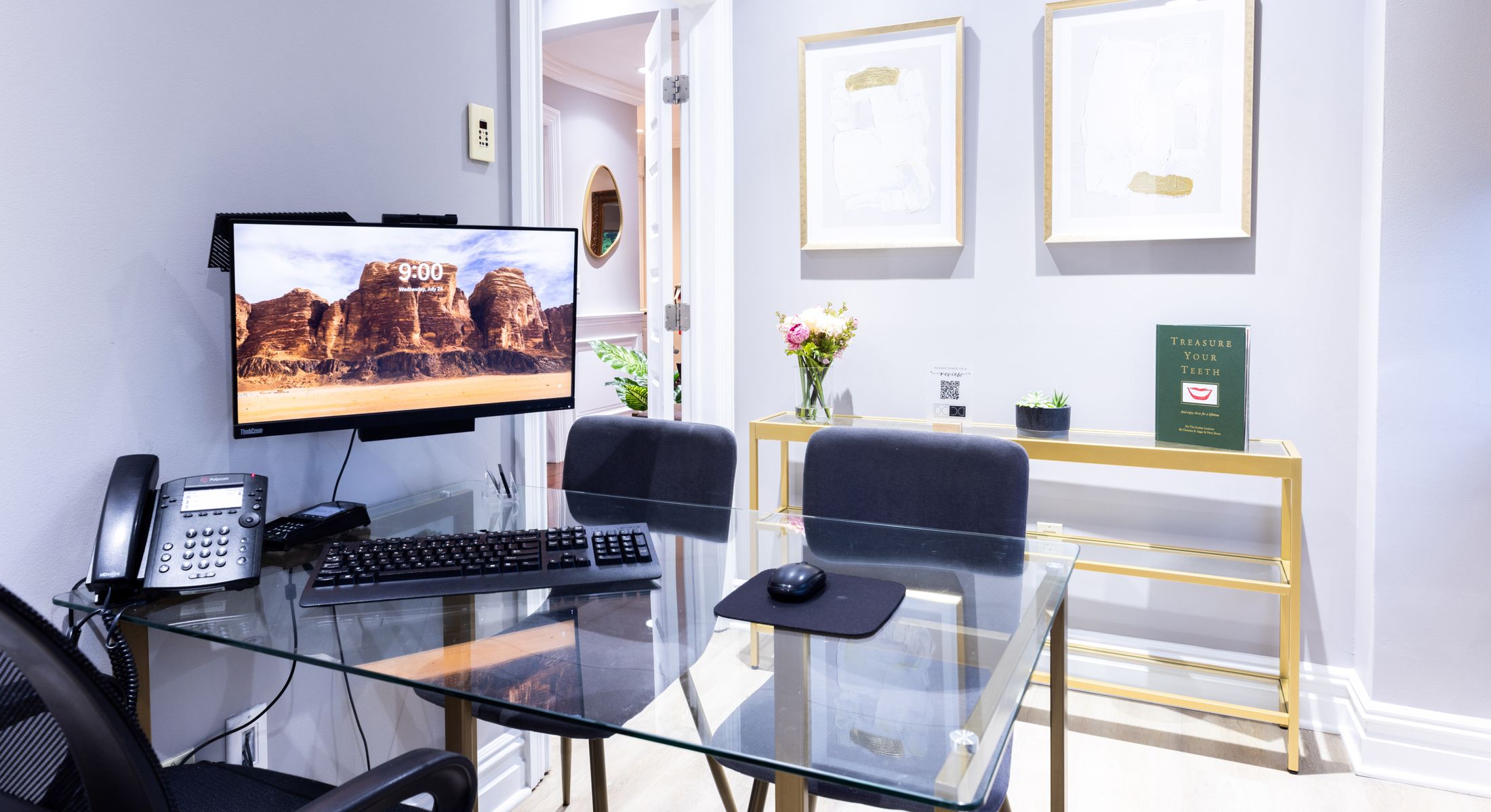 Modern office workspace with computer and decor.