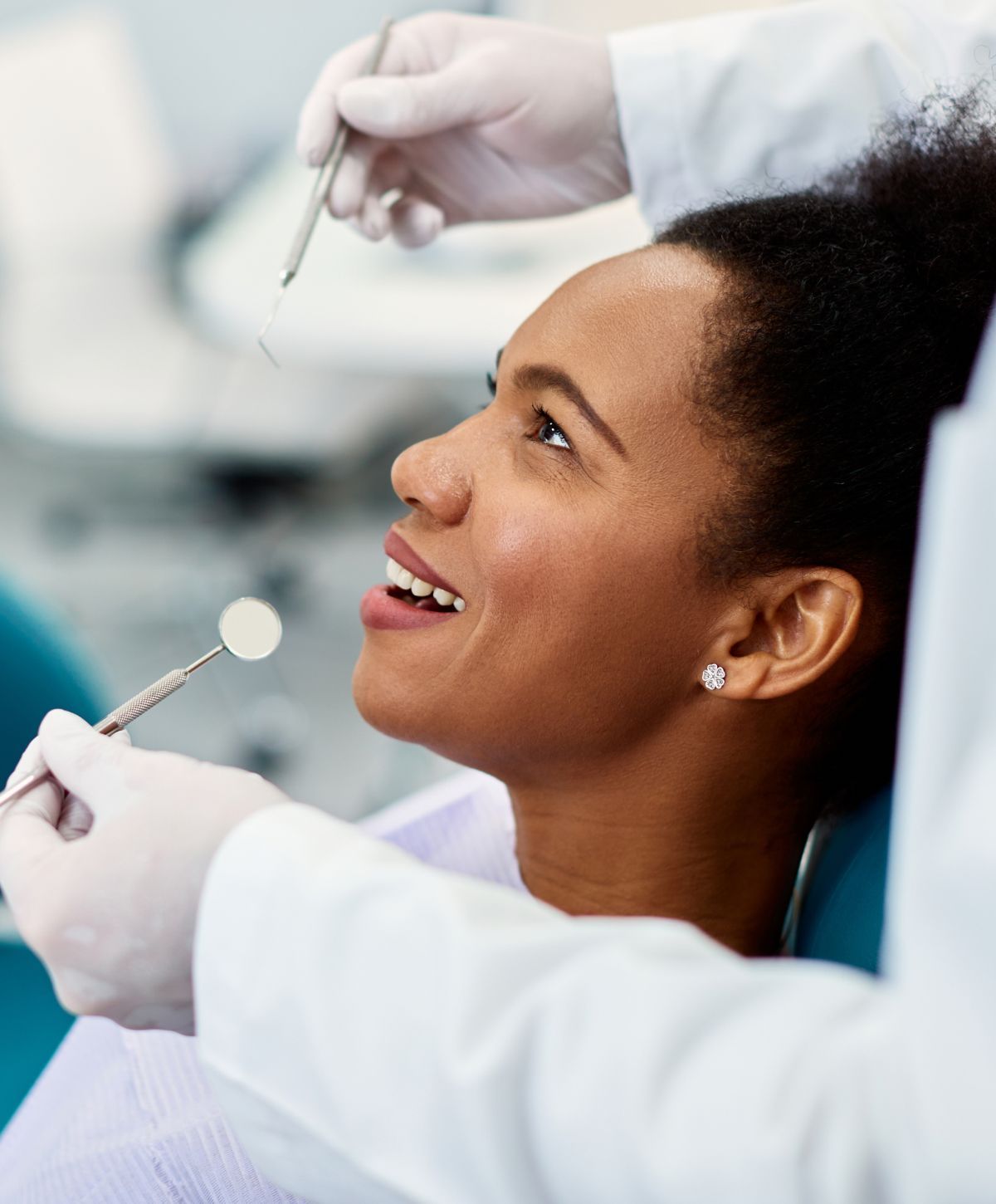 Patient smiling during dental examination.