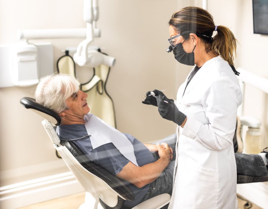 Dentist examining patient in dental office setting.