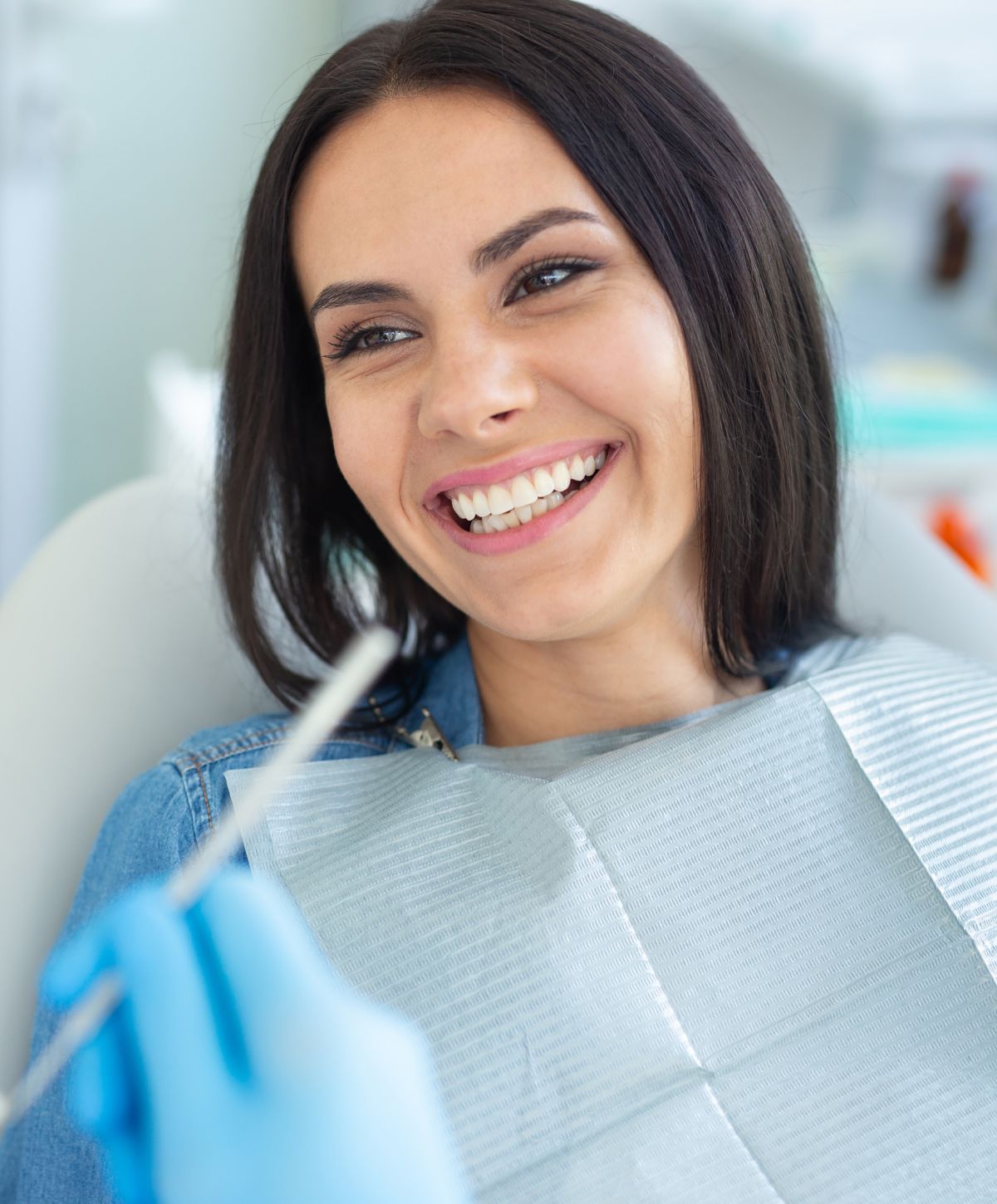 Patient smiling at dentist appointment.