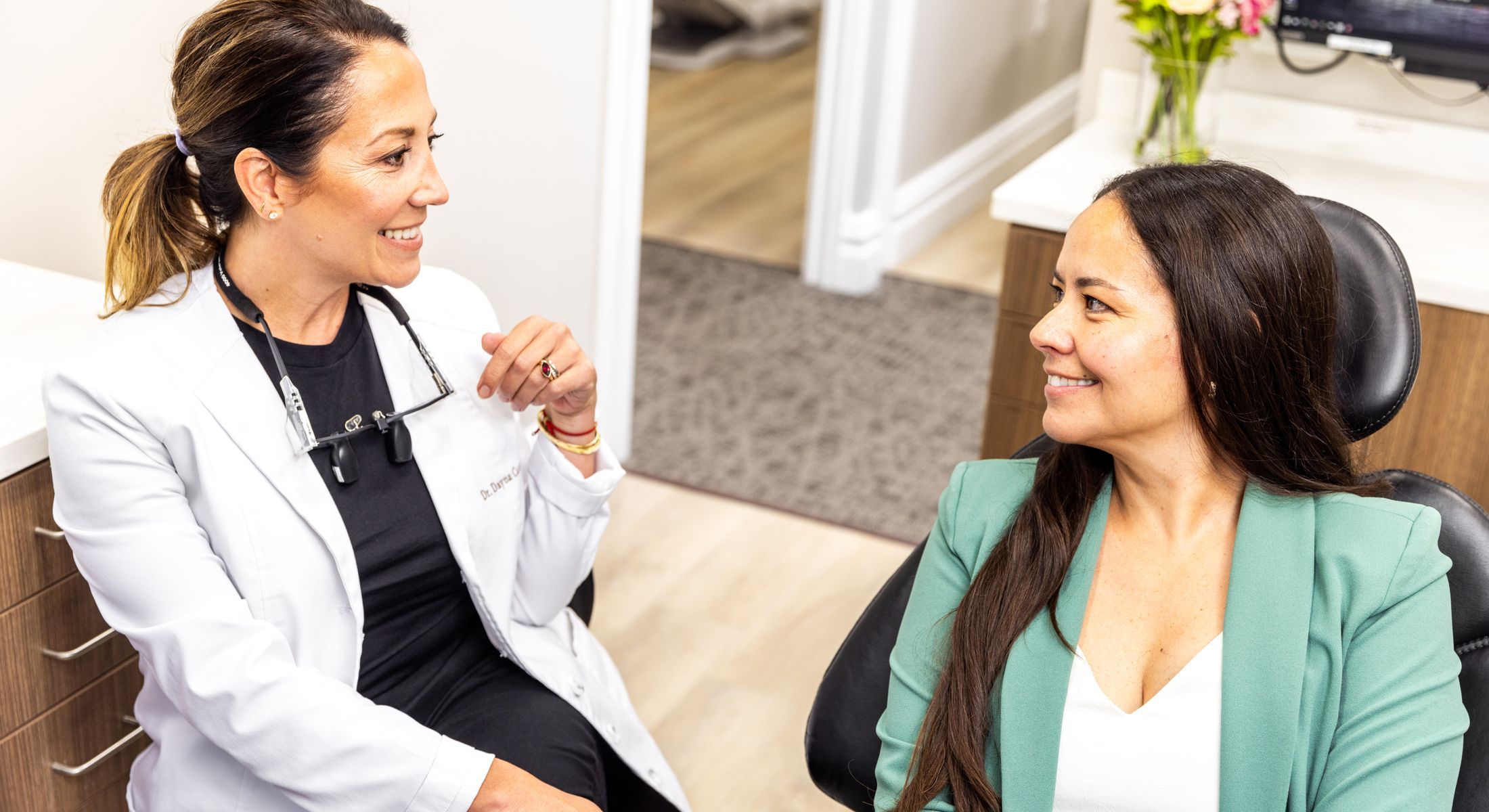 Dentist talking with a patient in office.