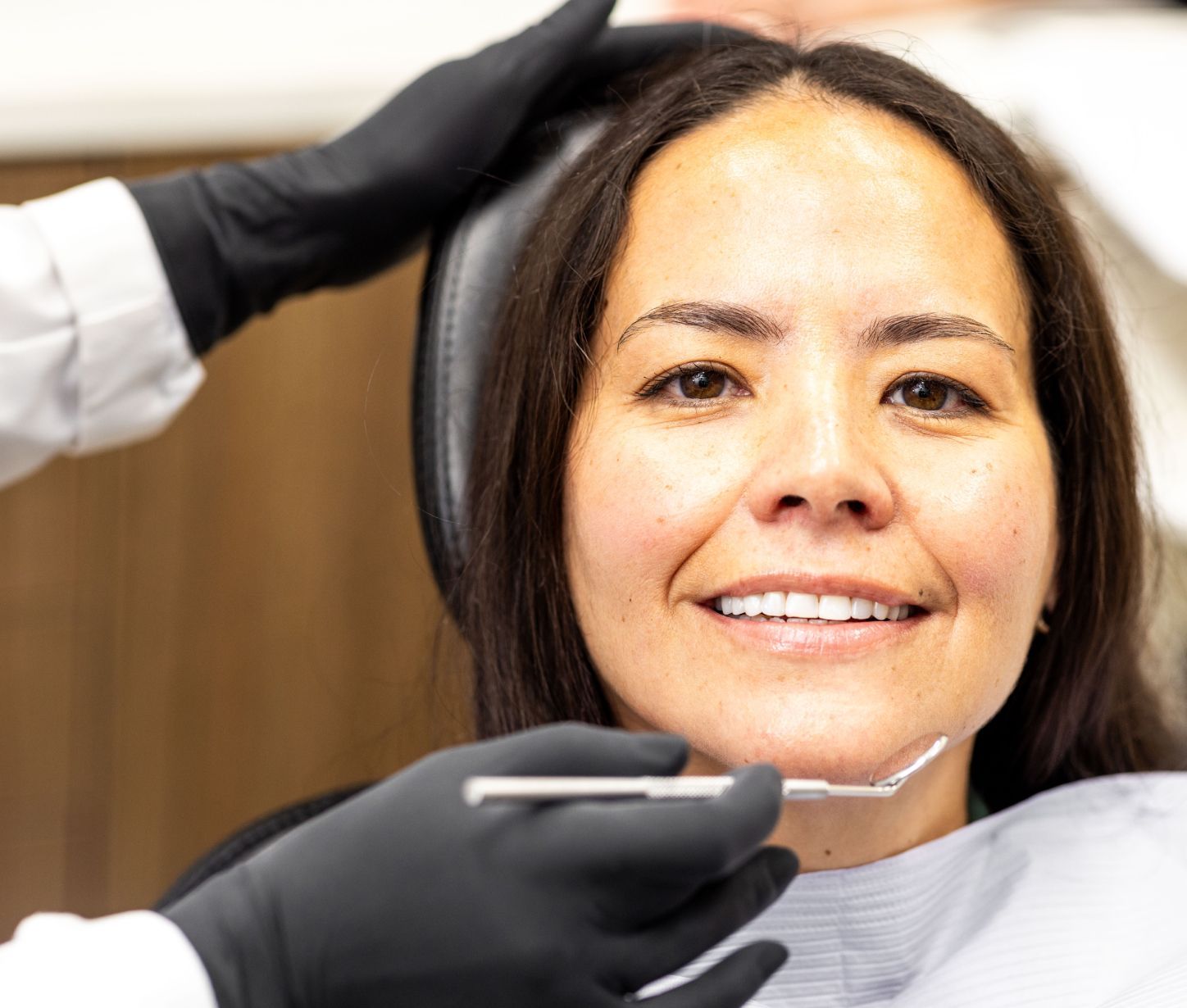 Patient smiling during dental check-up.