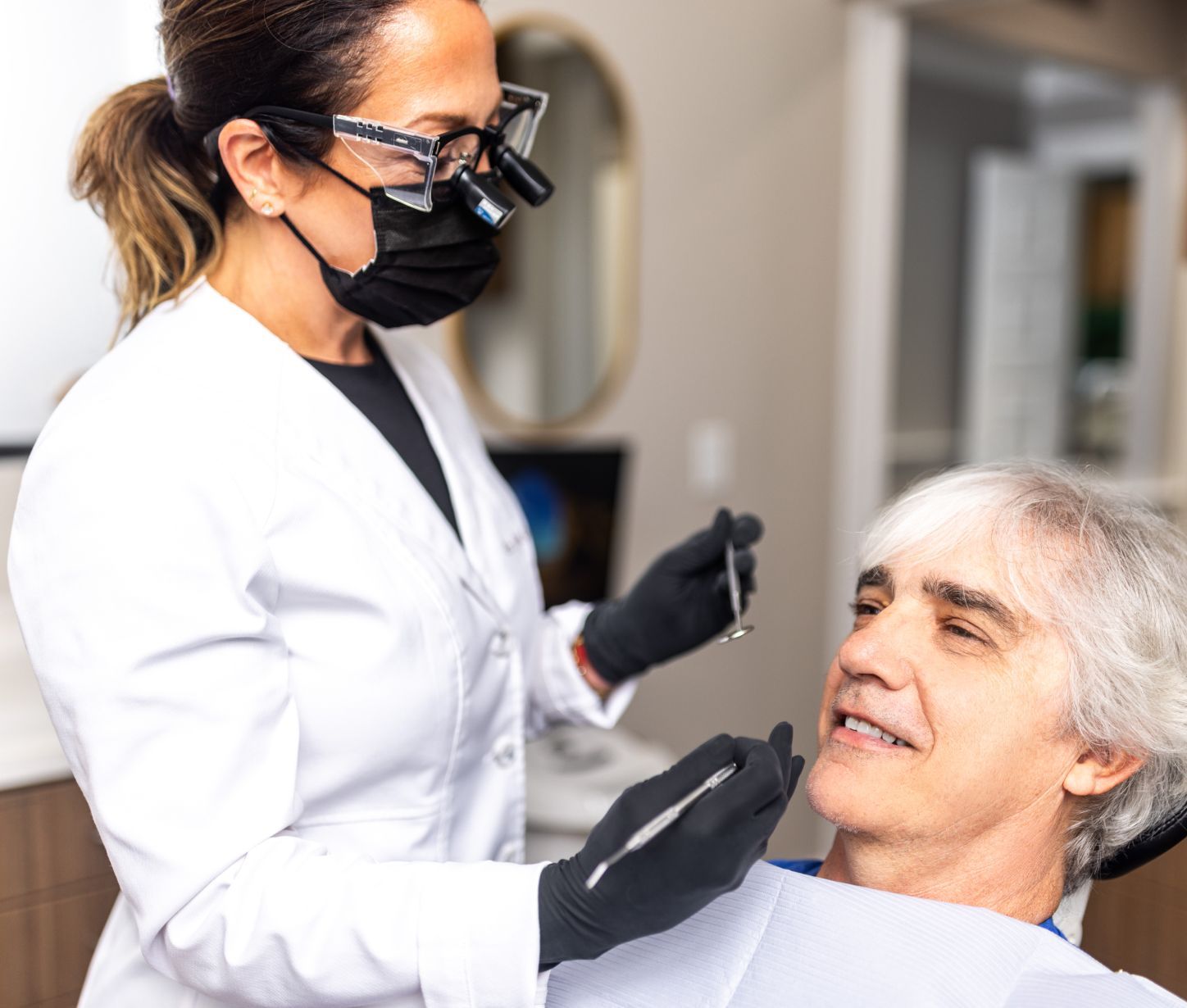 Dentist examining patient's teeth in clinic.