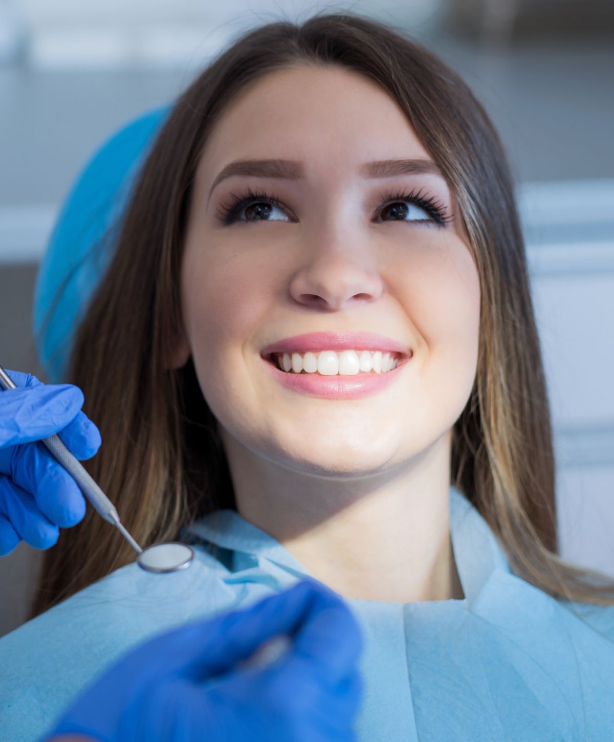 Patient smiling during dental check-up appointment.