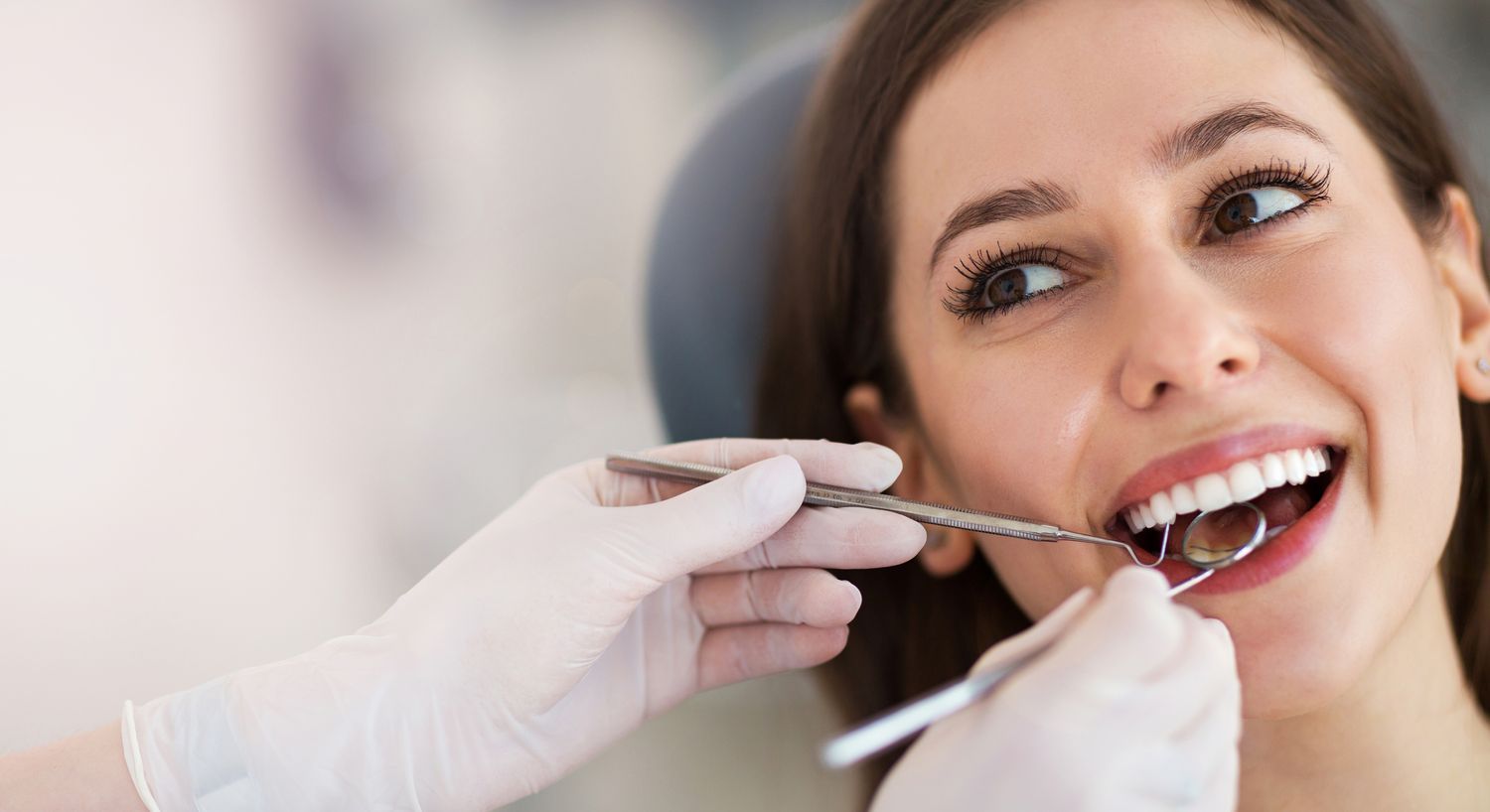 Patient receiving dental examination at clinic.