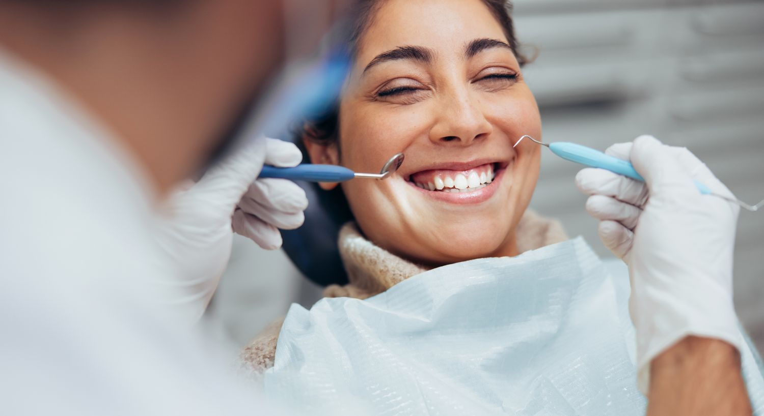 Patient smiling during dental check-up appointment.